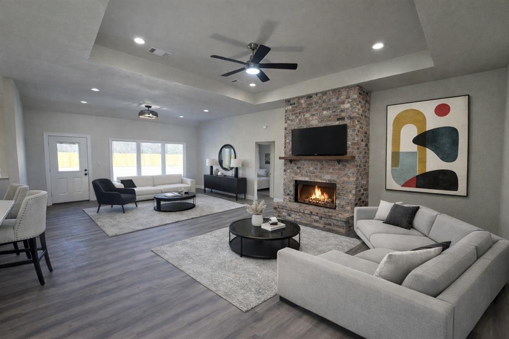 25 Pear Tree Lane Collinsville, TX 76233 - Photo 8 of 34 a living room with furniture a fireplace and a flat screen tv