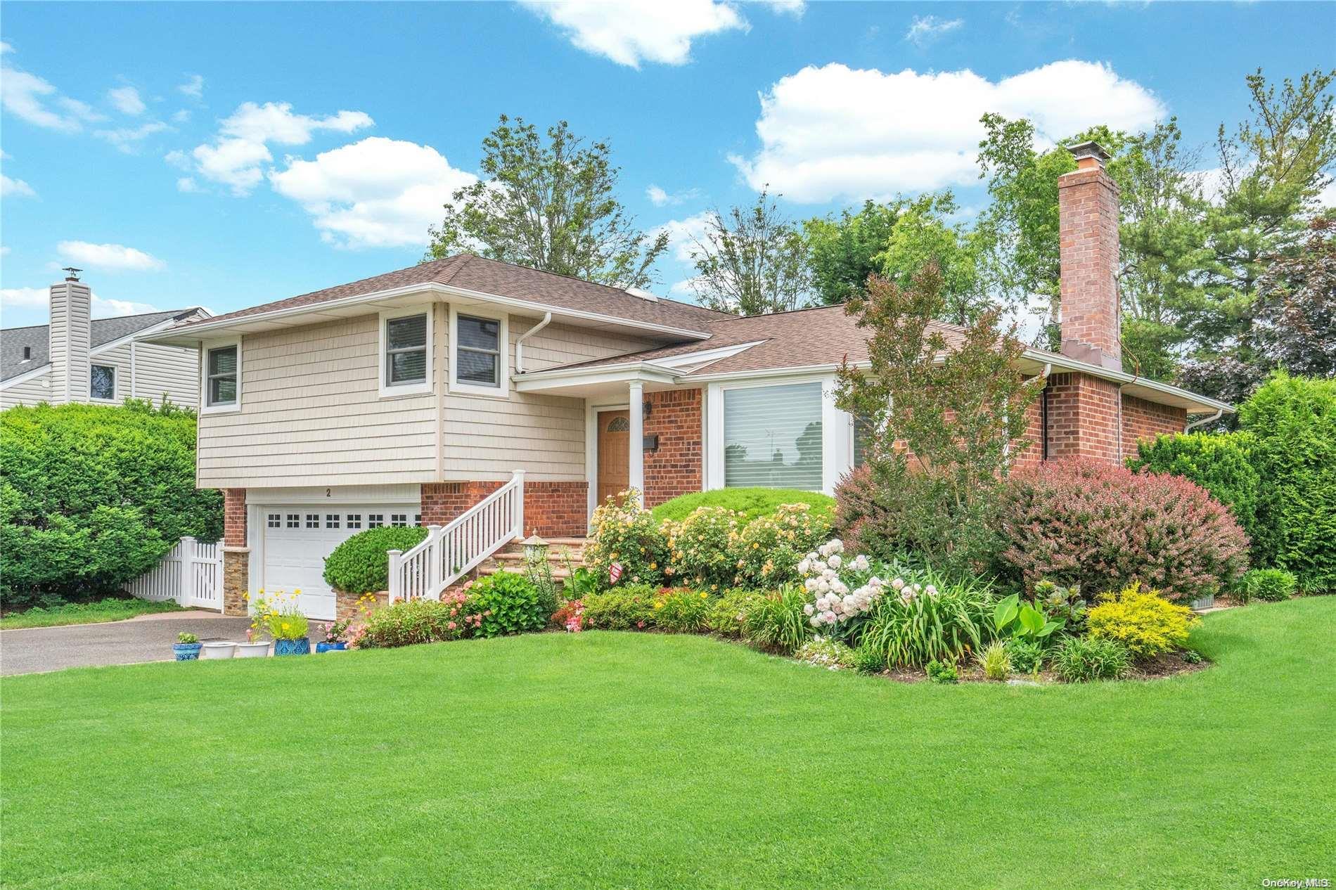 2 Steven Lane Plainview, NY 11803 - Photo 1 of 1 a front view of a house with a garden
