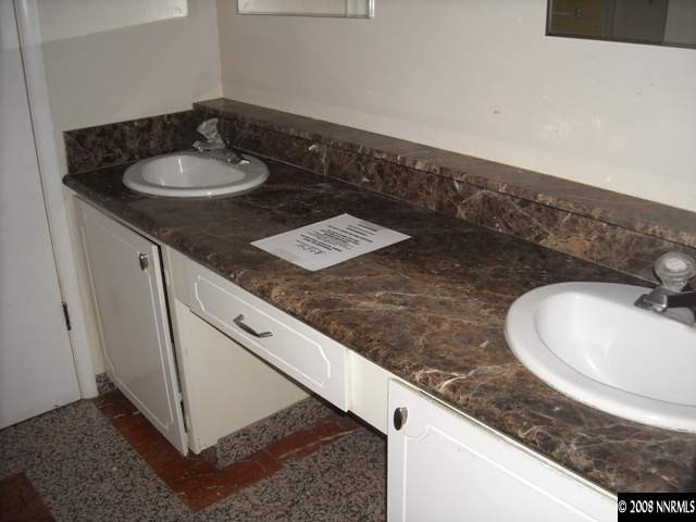 384 Smithridge Drive Reno, NV 89502 - Photo 3 of 3 a bathroom with a granite countertop sink and a mirror