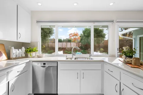 a kitchen with a sink and large window