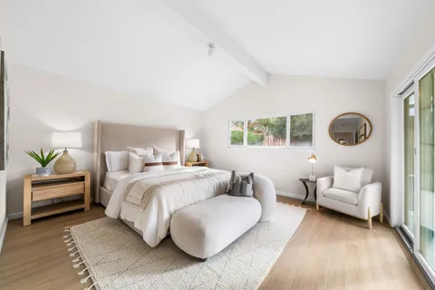 a bedroom with a bed couch and a window