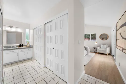 a bathroom with a granite countertop sink a toilet and a mirror