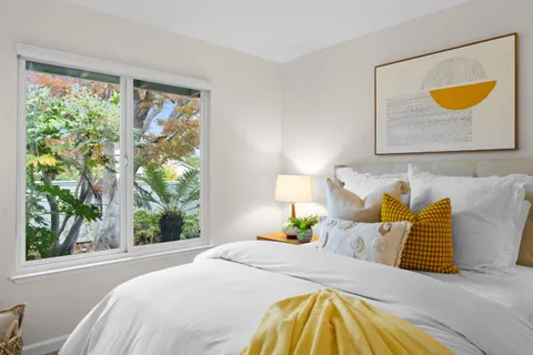 a bedroom with a bed and a window