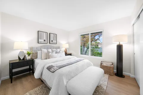 a bedroom with a bed and a large mirror