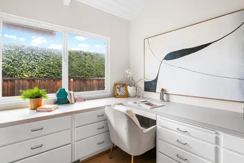 a spacious bathroom with a double vanity sink and a mirror