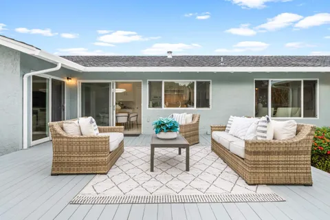 a front view of a house with swimming pool having outdoor seating