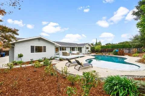 a view of a swimming pool with a lounge chairs