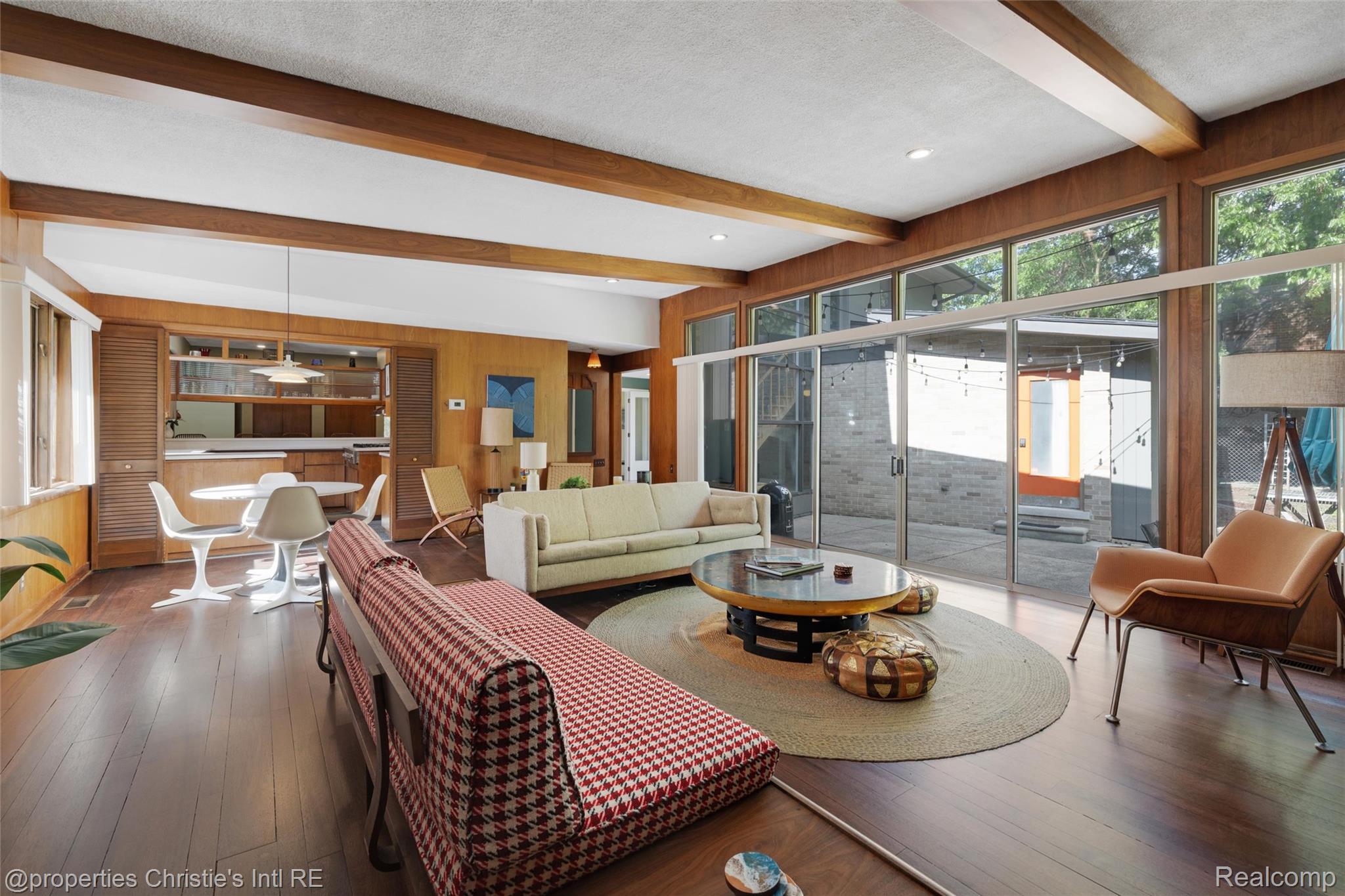 2771 West Seven Mile Road Detroit, MI 48221 - Photo 6 of 57 Spacious living area featuring wood-finish flooring, exposed ceiling beams, and extensive floor-to-ceiling windows