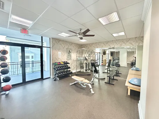 a room with lots of table chair and a large window