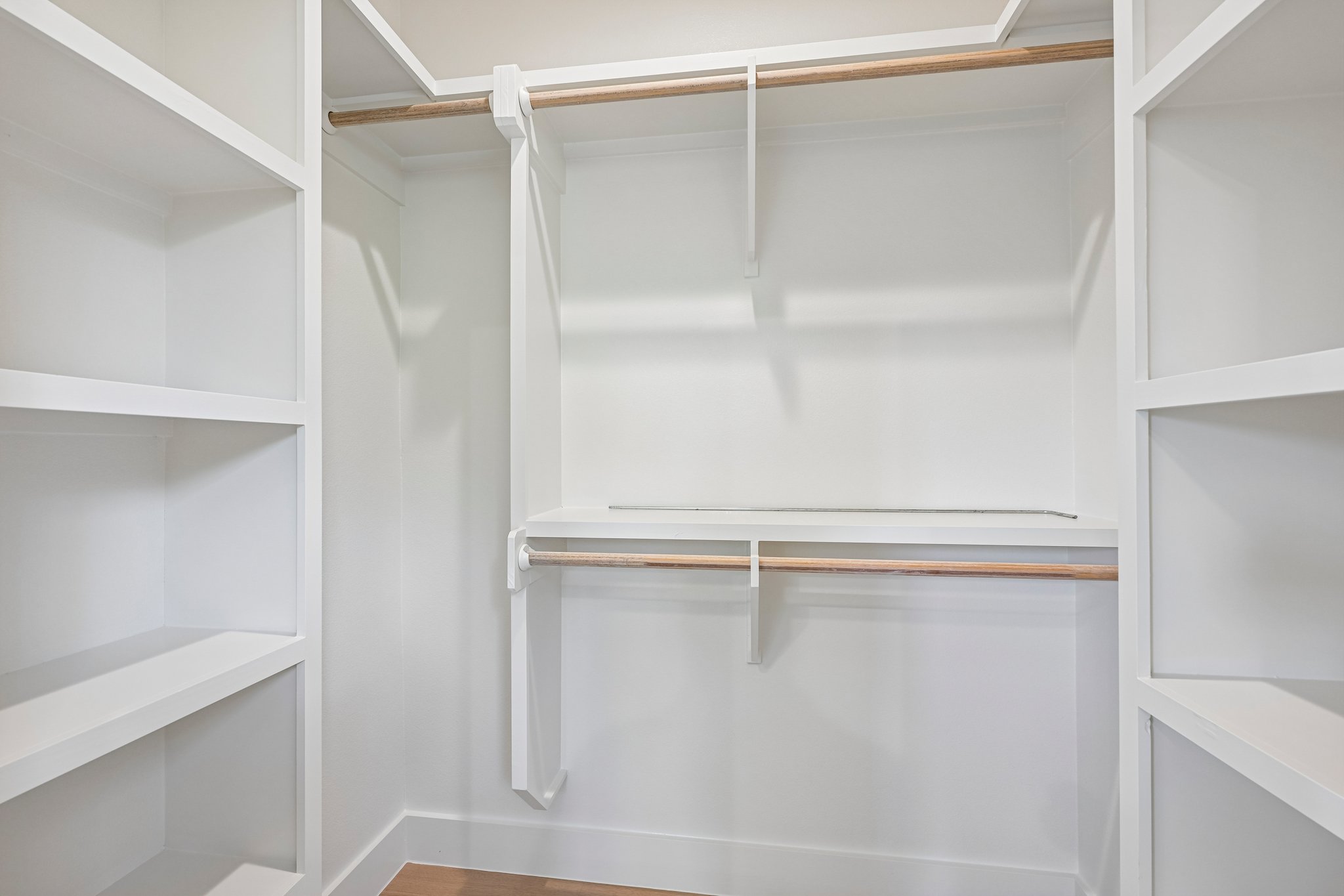 513 West Odell Street, Unit B Austin, TX 78752 - Photo 20 of 38 Ample shelving and hanging space defines this meticulously organized primary bedroom walk-in closet.