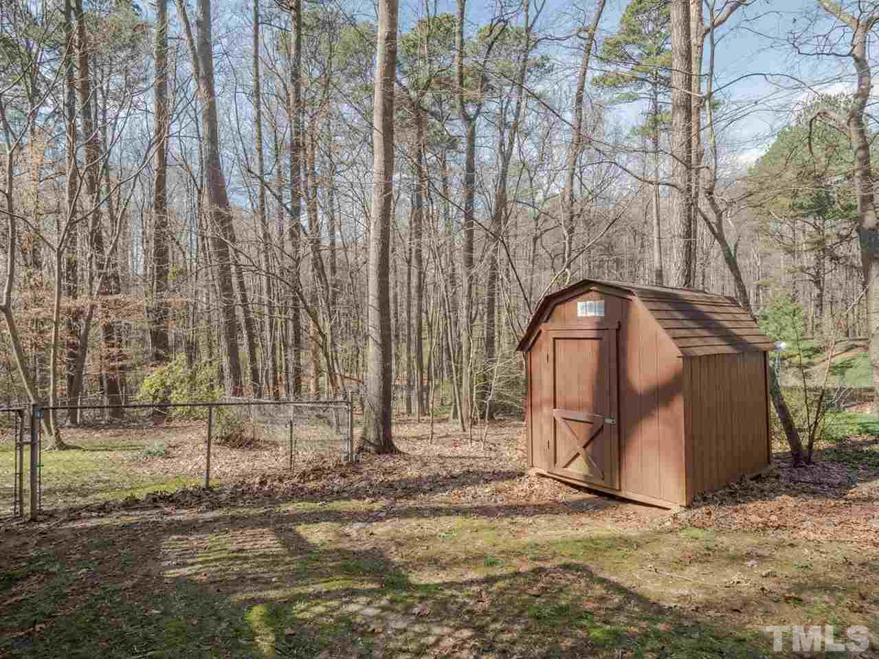 8317 Druids Lane Raleigh, NC 27613 - Photo 20 of 24 Custom shed in backyard for additional exterior storage.
