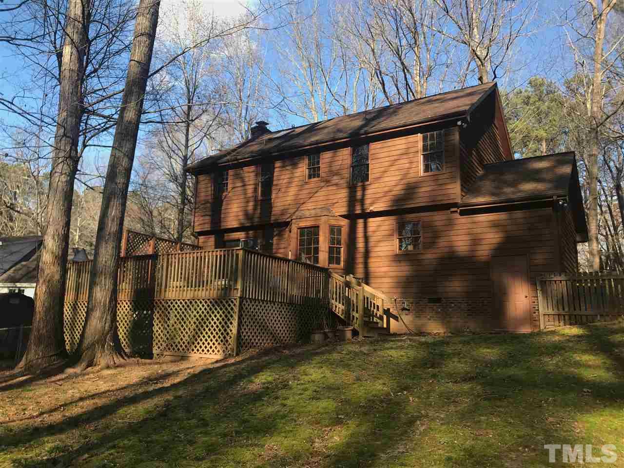 8317 Druids Lane Raleigh, NC 27613 - Photo 21 of 24 An expansive deck overlooks a fenced back yard and wooded natural area.