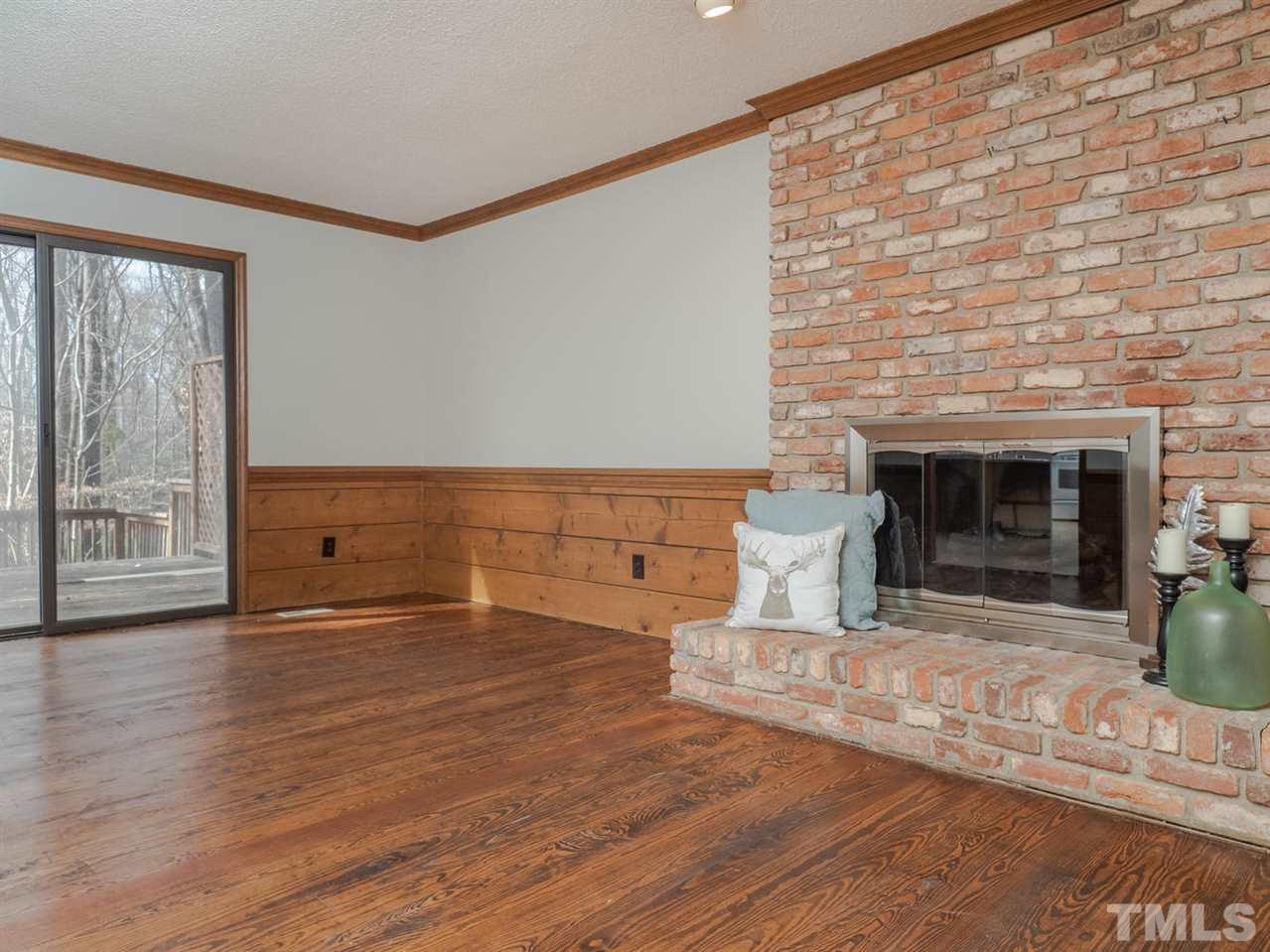 8317 Druids Lane Raleigh, NC 27613 - Photo 7 of 24 Masonry fireplace is wood burning.