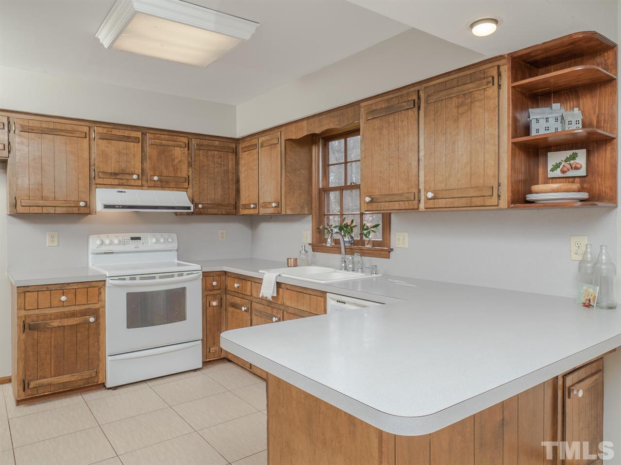 8317 Druids Lane Raleigh, NC 27613 - Photo 10 of 24 Kitchen has plenty of storage and great views to the backyard.