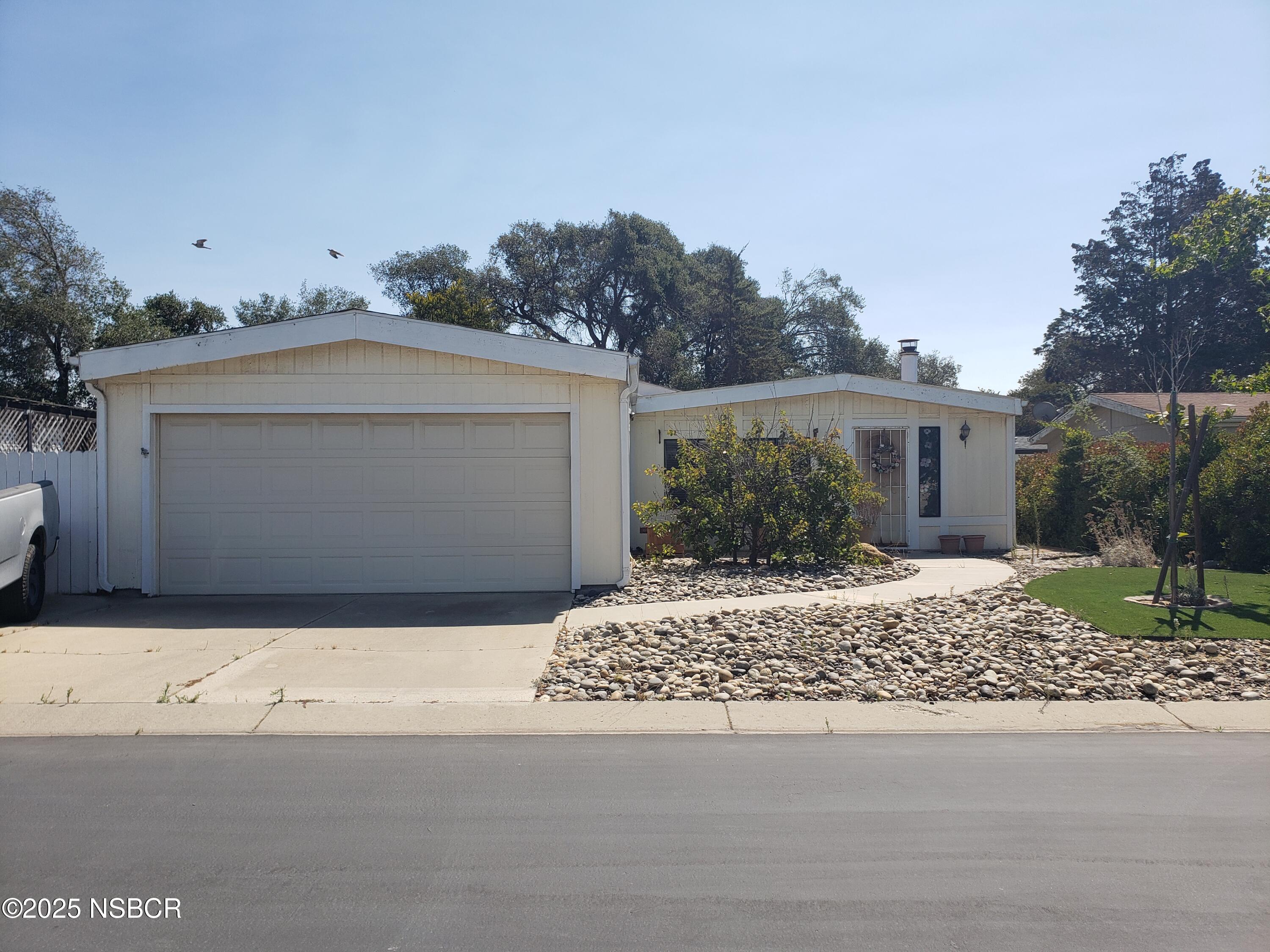 3822 Cherry Hill Road Santa Maria, CA 93455 - Photo 1 of 22 a front view of a house with a yard and garage