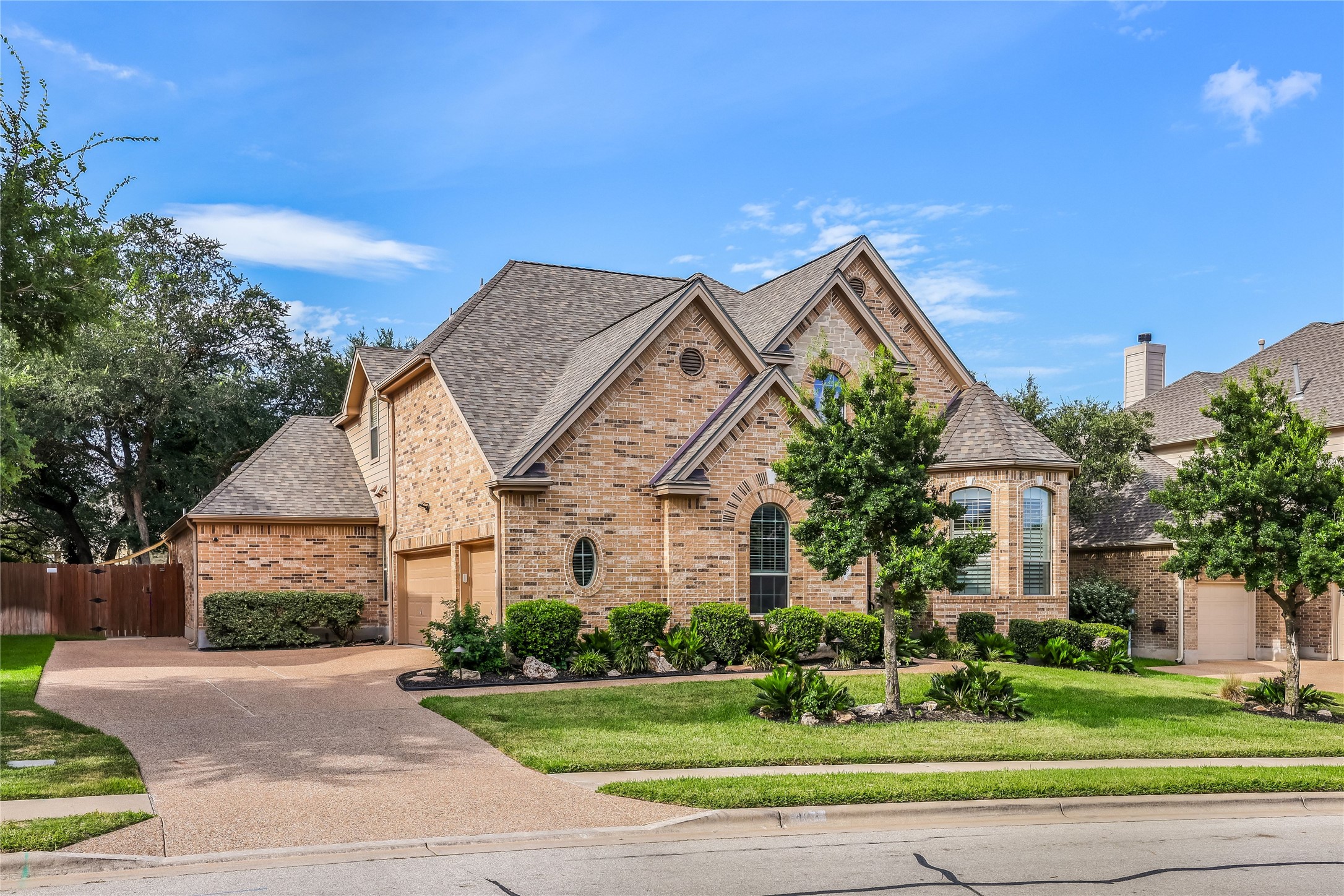 408 Ridgetop Bend Cedar Park, TX 78613 - Photo 1 of 40 A well-manicured lawn complements this classic brick home, featuring an attached garage and arched window details.