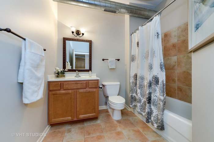 1200 West Monroe Street, Unit 502 Chicago, IL 60607 - Photo 14 of 20 a bathroom with a sink toilet a mirror and shower
