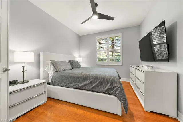 a spacious bedroom with a bed and a flat screen tv