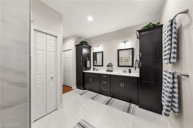 a spacious bathroom with a double vanity sink and mirror