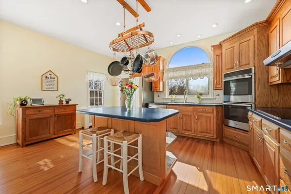 a living room with wooden floors furniture and a chandelier