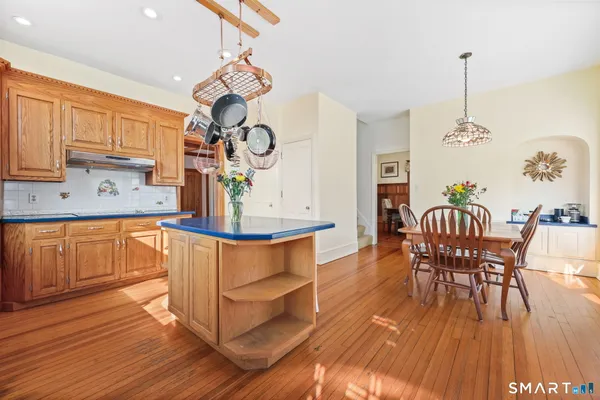 a view of a dining room with furniture wooden floor and a chandelier