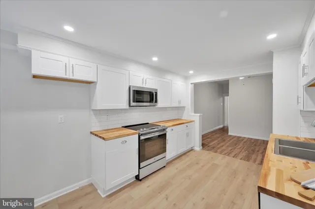 a kitchen with stainless steel appliances granite countertop a stove and a sink