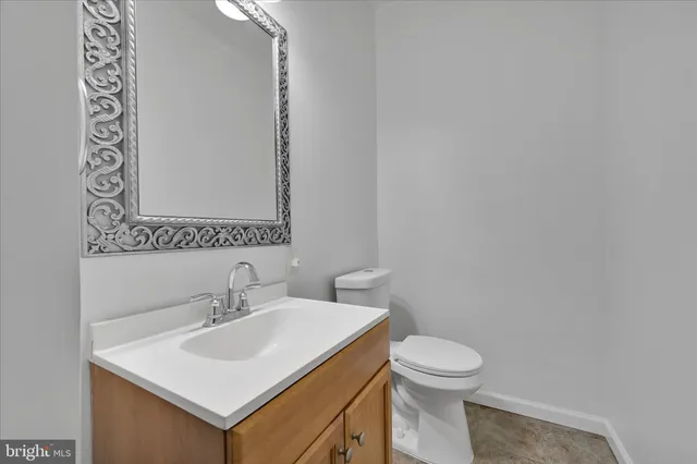 a bathroom with a sink a toilet and mirror