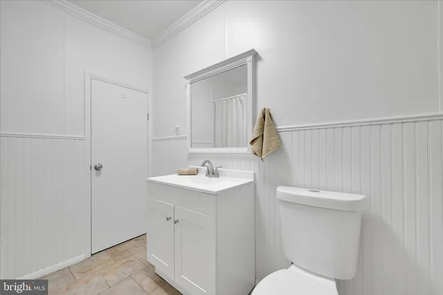 a bathroom with a sink a toilet and vanity