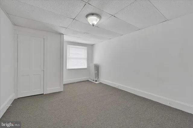 an empty room with a empty space and windows