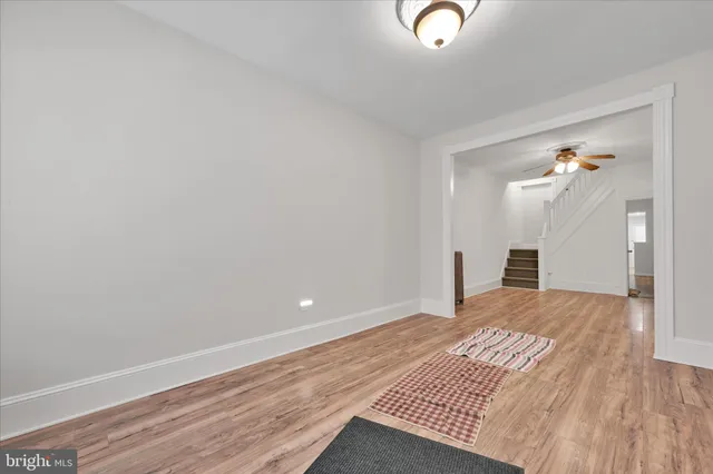 a view of an empty room and wooden floor