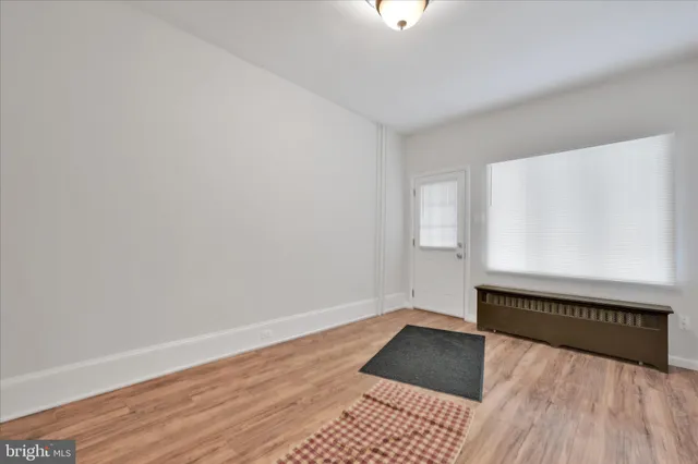 a view of an empty room and wooden floor