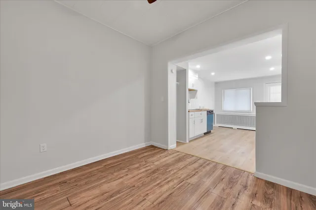 a view of a kitchen with wooden floor and a sink
