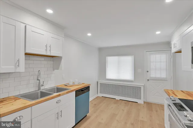 a kitchen with a sink cabinets and window