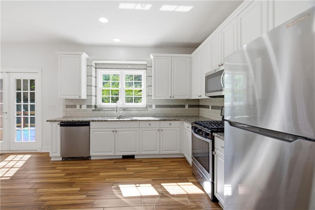 110 Mayes Farm Road Northwest Marietta, GA 30064 - Photo 18 of 49 a kitchen with granite countertop a refrigerator sink and stove