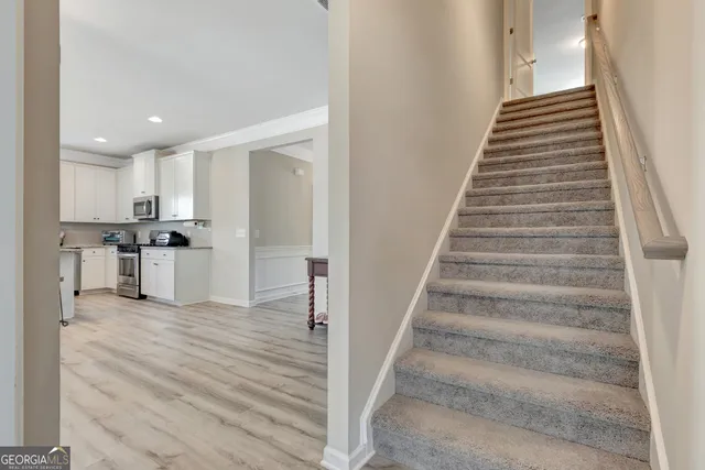 a view of kitchen with wooden floor and electronic appliances