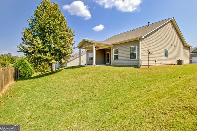 a view of a house with a yard and garage