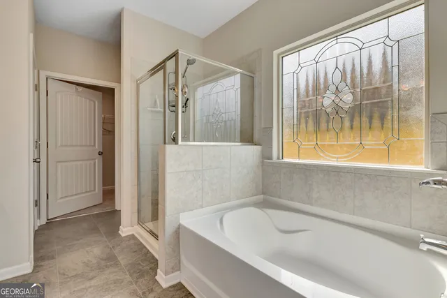 a bathroom with a tub and shower