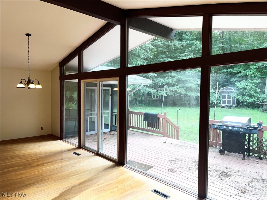 2300 River Road Willoughby, OH 44094 - Photo 8 of 28 Entryway featuring light wood finished floors, a chandelier, and floor to ceiling windows