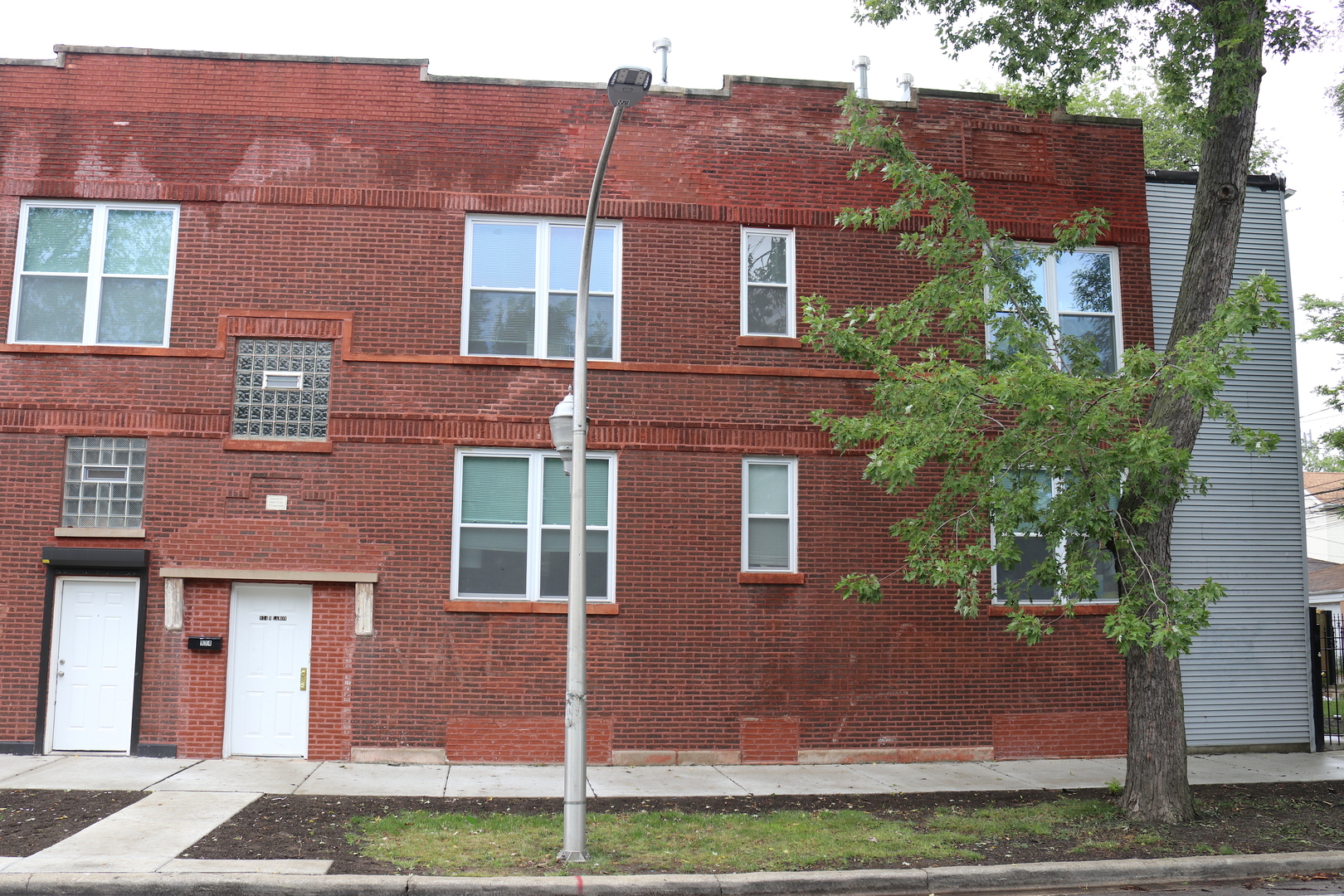 934 North Lamon Avenue, Unit 2 Chicago, IL 60651 - Photo 1 of 7 a view of a brick building next to a yard