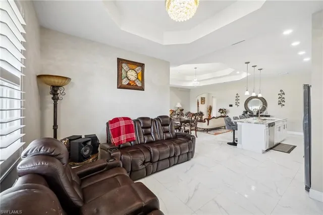 a living room with furniture a rug and a mirror
