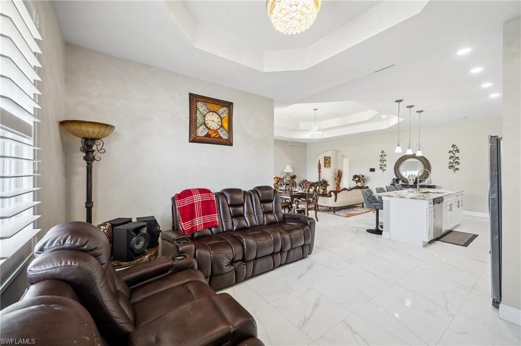 3407 20th Street Southwest Lehigh Acres, FL 33976 - Photo 11 of 23 a living room with furniture a rug and a mirror