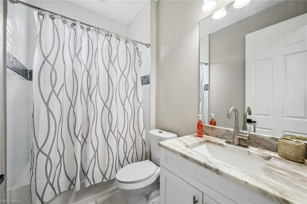 3407 20th Street Southwest Lehigh Acres, FL 33976 - Photo 16 of 23 a bathroom with a granite countertop sink and a toilet