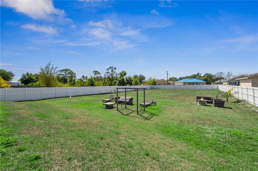 3407 20th Street Southwest Lehigh Acres, FL 33976 - Photo 22 of 23 a view of a lake with houses in the back