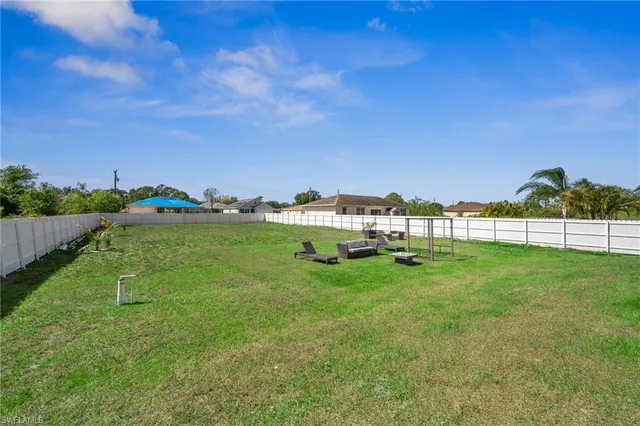 a view of yard with swimming pool and green space
