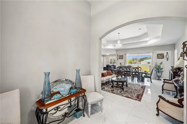 a living room with furniture a rug and gym equipment