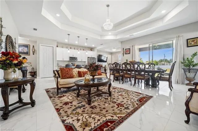 a living room with lots of furniture and kitchen view