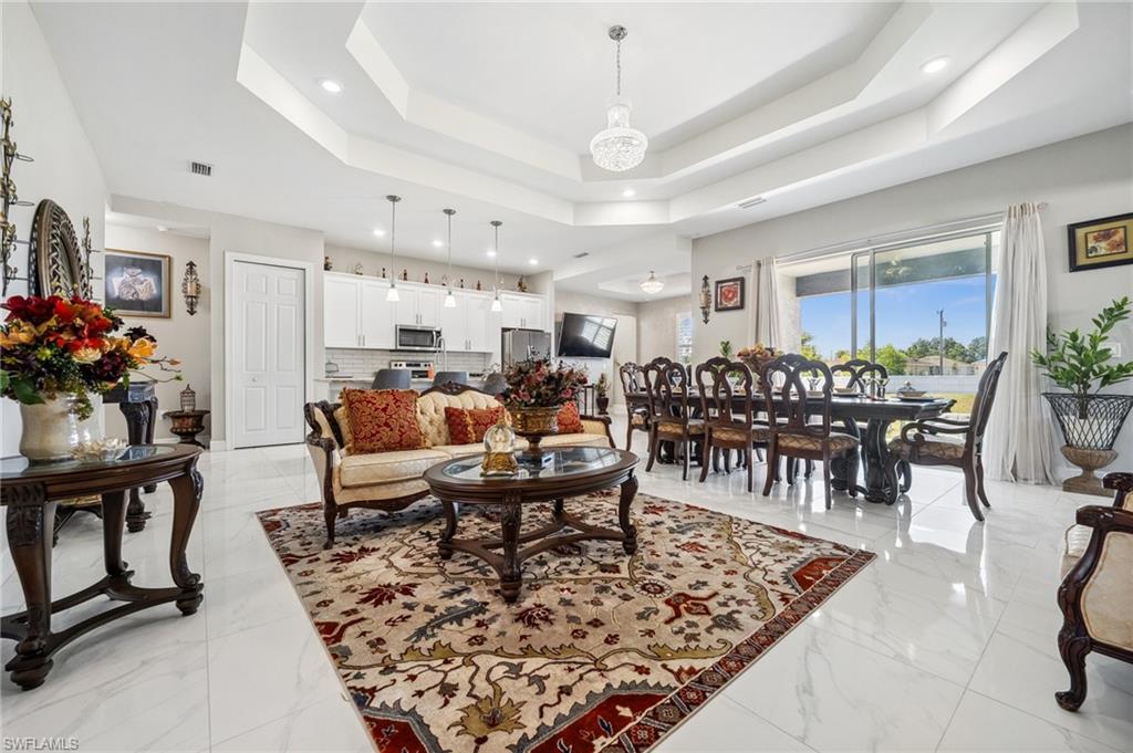 3407 20th Street Southwest Lehigh Acres, FL 33976 - Photo 6 of 23 a living room with lots of furniture and kitchen view