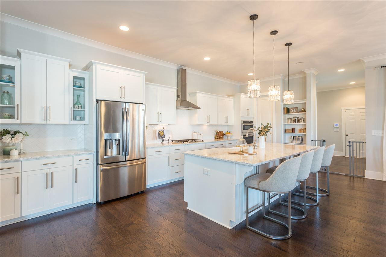 5410 Beckom Street Raleigh, NC 27616 - Photo 1 of 30 Custom kitchen with quartz counters, SS appliances, tons of storage and a custom farmhouse sink. Plus it has a HUGE walk in pantry with custom shelving! Kitchen