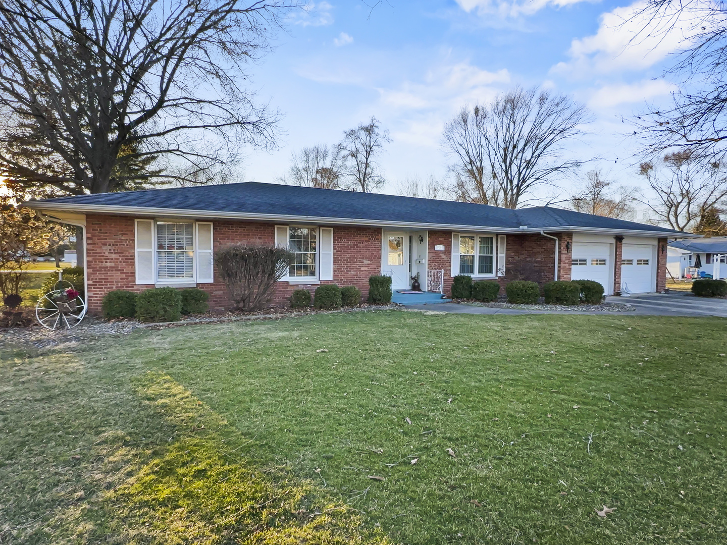 a front view of house with yard and green space