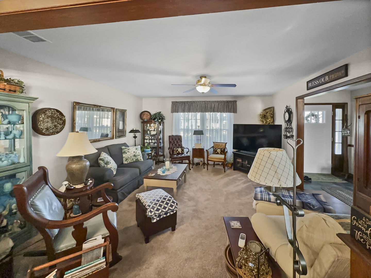 447 South Ralph Street Watseka, IL 60970 - Photo 3 of 20 a living room with furniture a flat screen tv and a table